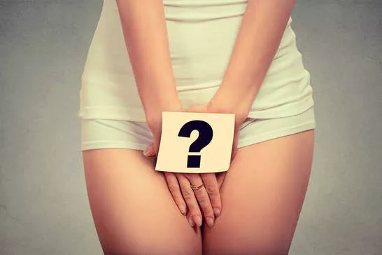 Woman covering up her genital area with a question mark covering her vulva (she's clothed). A Plymouth, MN sex and relationship therapist can help. Read on for help in Plymouth, MN 55369 | 55361 | 55391