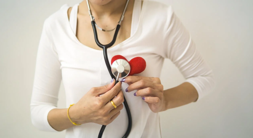 woman holding stethoscope to heart, why sex is good for you, sex and heart disease 