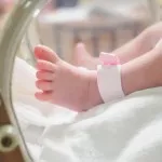Newborn baby leg with hospital anklet