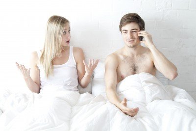 Minimalist Sex Lesson - Operation，Man using his phone in bed while his wife expresses frustration