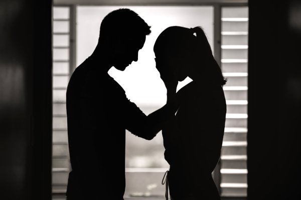 A man comforts his crying wife