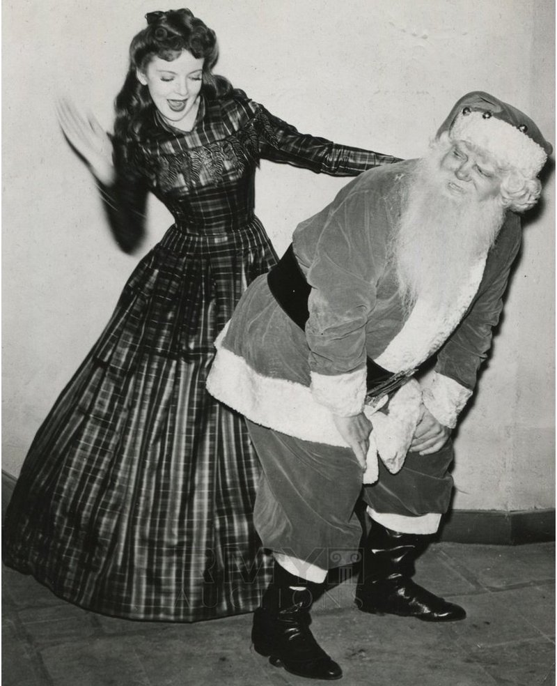 Santa Claus gets spanked by Hollywood actress in long dress