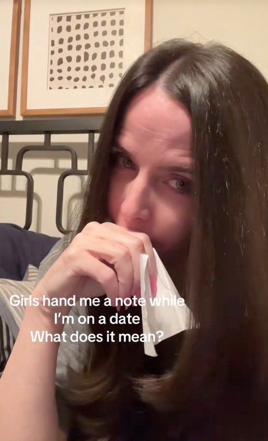 A shocking woman, long hair and long hair, holding a mysterious note in her mouth