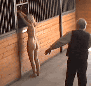 Blonde gets whipped in stable