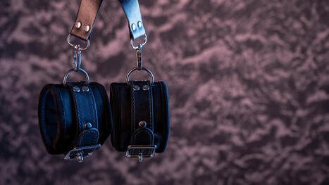 Handcuffs for kink playback or BDSM with blurred background. In Sex Therapy in Plymouth, Minnesota or Online Sex Therapy in Minnesota, consider a sex therapist near Minneapolis. 55369 | 55361 | 55391