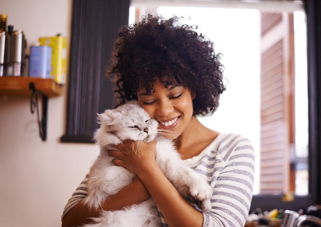 Woman hugging cat