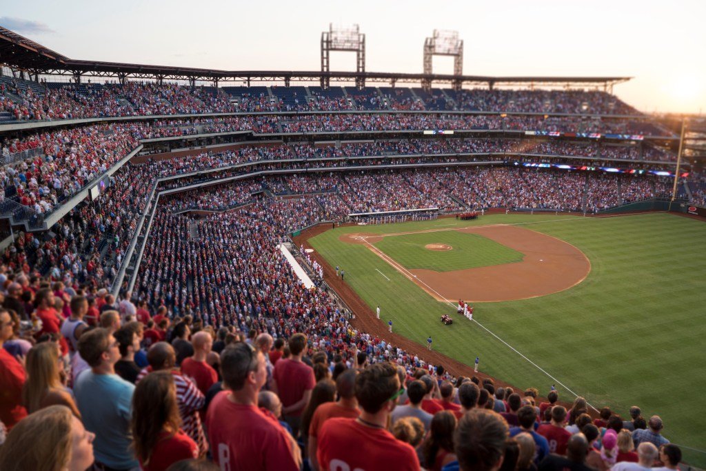 High angle landscape, a crowded baseball field with spectators and players on the field.